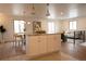 Bright, open-concept layout showcasing kitchen island, dining area, and living space with hardwood floors at 2300 S Krameria St, Denver, CO 80222