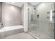 Spa-like bathroom with soaking tub, walk-in shower, and tile details at 4200 W 17Th Ave # 311, Denver, CO 80204