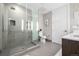 Modern bathroom with a glass shower, toilet and tiled floors at 4200 W 17Th Ave # 311, Denver, CO 80204