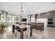 Open concept dining area with wood table and modern chandelier at 4200 W 17Th Ave # 311, Denver, CO 80204