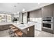 Modern kitchen with island, stainless steel appliances, and breakfast bar at 4200 W 17Th Ave # 311, Denver, CO 80204