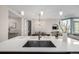 Modern kitchen island with sink and breakfast bar at 4200 W 17Th Ave # 311, Denver, CO 80204