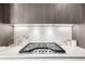 Modern gas cooktop with sleek white backsplash at 4200 W 17Th Ave # 311, Denver, CO 80204