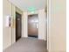 Building hallway with fire exit and unit doors at 7755 E Quincy Ave # 101, Denver, CO 80237