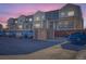 Townhouses with parking and shared dumpster area at dusk at 4537 Tabor St, Wheat Ridge, CO 80033