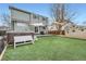 Backyard showcasing artificial turf, above ground hot tub, and a decorative shed at 10529 Vaughn Way, Commerce City, CO 80022