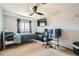 Spacious bedroom features a ceiling fan, window and a desk setup at 10529 Vaughn Way, Commerce City, CO 80022