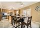 Open dining area with a ceiling fan, adjacent to the kitchen and backyard access at 10529 Vaughn Way, Commerce City, CO 80022