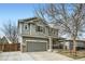 Charming two-story home with a well-maintained front yard and covered entry porch at 10529 Vaughn Way, Commerce City, CO 80022