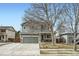 Inviting two-story house with a front-facing two car garage, set against a clear blue sky at 10529 Vaughn Way, Commerce City, CO 80022