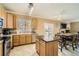 Well-lit kitchen with granite countertop island, modern appliances and dining area at 10529 Vaughn Way, Commerce City, CO 80022