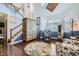 Bright living room with high ceilings, wood floors, and a staircase leading to the upper level at 10529 Vaughn Way, Commerce City, CO 80022