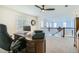 Office featuring wooden desk, ceiling fan, and window next to upstairs landing at 10529 Vaughn Way, Commerce City, CO 80022