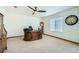 Bright office featuring a ceiling fan, traditional wooden desk, and a large window at 10529 Vaughn Way, Commerce City, CO 80022