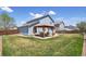 Landscaped backyard with wooden pergola and patio area perfect for outdoor entertaining at 11416 E 114Th Ave, Commerce City, CO 80640