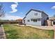 Large backyard with grass and a wooden pergola sitting on a patio area at 11416 E 114Th Ave, Commerce City, CO 80640