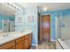 Bathroom with double sink vanity, wood-look floors, and separate tub and shower at 11416 E 114Th Ave, Commerce City, CO 80640