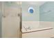 Bathroom with a large tub and a separate glass enclosed shower at 11416 E 114Th Ave, Commerce City, CO 80640