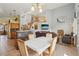 Open layout with view of dining area and living room with fireplace, hardwood floors, and ample seating at 11416 E 114Th Ave, Commerce City, CO 80640