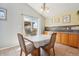 Cozy dining area with natural light, tile floors, and a view of the outdoor patio at 11416 E 114Th Ave, Commerce City, CO 80640