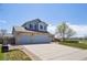 Two-story home with stone accents, a three-car garage, and a well-maintained front yard at 11416 E 114Th Ave, Commerce City, CO 80640