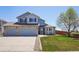 Charming two-story home featuring a stone facade, two-car garage, and manicured front lawn at 11416 E 114Th Ave, Commerce City, CO 80640