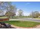 Landscaped front yard features a fire pit, bench, and views of the open green space across the street at 11416 E 114Th Ave, Commerce City, CO 80640
