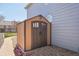 Durable storage shed with double doors on gravel near a brick-lined path at 11416 E 114Th Ave, Commerce City, CO 80640