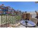 Cozy balcony with table and seating, offering views of the neighborhood at 9546 Firenze Way, Highlands Ranch, CO 80126