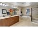 Bright bathroom featuring double vanity, soaking tub, and tiled walk-in shower at 9546 Firenze Way, Highlands Ranch, CO 80126