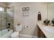 Bathroom with a tiled shower-over-tub, toilet, and single vanity sink at 9546 Firenze Way, Highlands Ranch, CO 80126