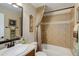 Bathroom featuring tiled tub/shower combo, vanity, framed mirror, and neutral wall color at 9546 Firenze Way, Highlands Ranch, CO 80126