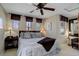 Bedroom with a ceiling fan, carpet, and windows with custom shades at 9546 Firenze Way, Highlands Ranch, CO 80126