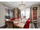 Bright dining room with contemporary chandelier and sliding glass door to an outdoor patio at 9546 Firenze Way, Highlands Ranch, CO 80126