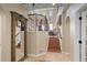 Spacious foyer with high ceilings, staircase, decorative statue, and views into other rooms at 9546 Firenze Way, Highlands Ranch, CO 80126