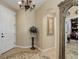 Elegant foyer with tiled flooring, decorative chandelier, and arched doorway to another room at 9546 Firenze Way, Highlands Ranch, CO 80126