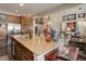 Kitchen with a large island with stainless steel appliances, granite countertops and dark wood floors at 9546 Firenze Way, Highlands Ranch, CO 80126
