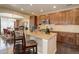 Gourmet kitchen with stainless steel appliances and center island with seating and granite countertops at 9546 Firenze Way, Highlands Ranch, CO 80126