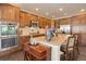 A bright kitchen features stainless steel appliances, granite countertops, and wooden cabinets at 9546 Firenze Way, Highlands Ranch, CO 80126