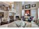 Spacious living room with a fireplace, high ceilings, dark hardwood floors, and ample natural light at 9546 Firenze Way, Highlands Ranch, CO 80126