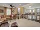 Open-concept living area features staircase, large windows, and comfortable seating at 9546 Firenze Way, Highlands Ranch, CO 80126