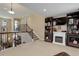 Second-floor living area featuring a beautiful railing, built-in shelving and fireplace at 9546 Firenze Way, Highlands Ranch, CO 80126