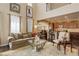 Inviting living room with hardwood floors, high ceilings, and an open view to the kitchen area at 9546 Firenze Way, Highlands Ranch, CO 80126