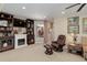 Bright living room featuring a fireplace, built-in shelving, and comfortable seating at 9546 Firenze Way, Highlands Ranch, CO 80126