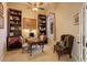 Cozy home office with built-in bookcases, a large window, and a comfortable armchair at 9546 Firenze Way, Highlands Ranch, CO 80126