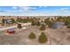 Wide aerial shot showcasing the property with a house, trees, and a unique red outbuilding at 6200 Bow Meadows Dr, Elizabeth, CO 80107
