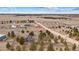 Sweeping aerial view of the property, highlighting the surrounding landscape and red outbuilding at 6200 Bow Meadows Dr, Elizabeth, CO 80107