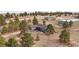Overhead shot featuring a gray single-Gathering home with surrounding trees and a long driveway at 6200 Bow Meadows Dr, Elizabeth, CO 80107