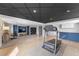 Finished basement with exercise area, tv area, and bar area with tile floor at 6200 Bow Meadows Dr, Elizabeth, CO 80107