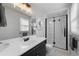 This bathroom features a sleek vanity, a framed mirror with accent lighting, and a luxurious shower with black trim at 6200 Bow Meadows Dr, Elizabeth, CO 80107